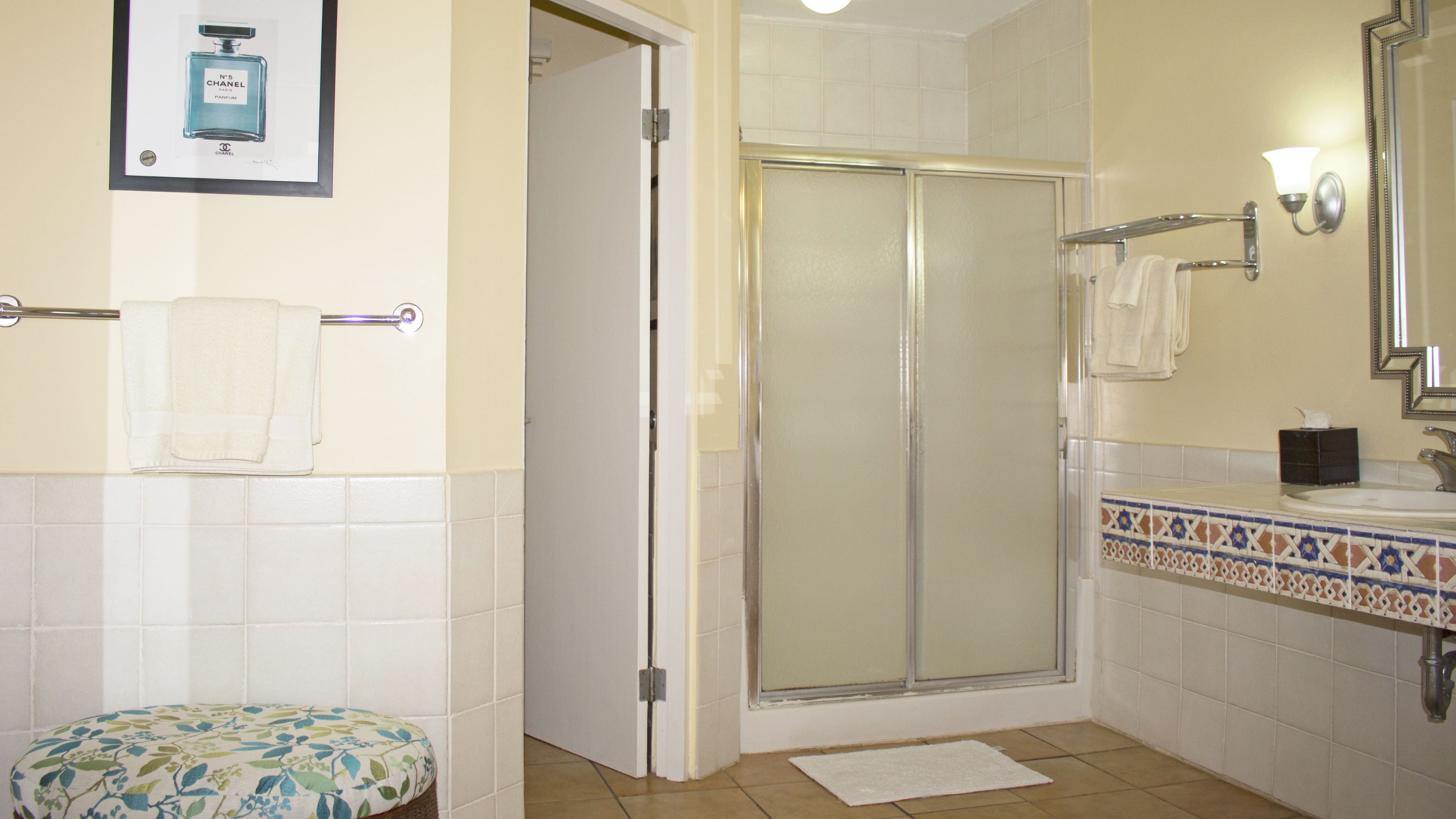 Bathroom is very spacious and has a shower and a hot tub 