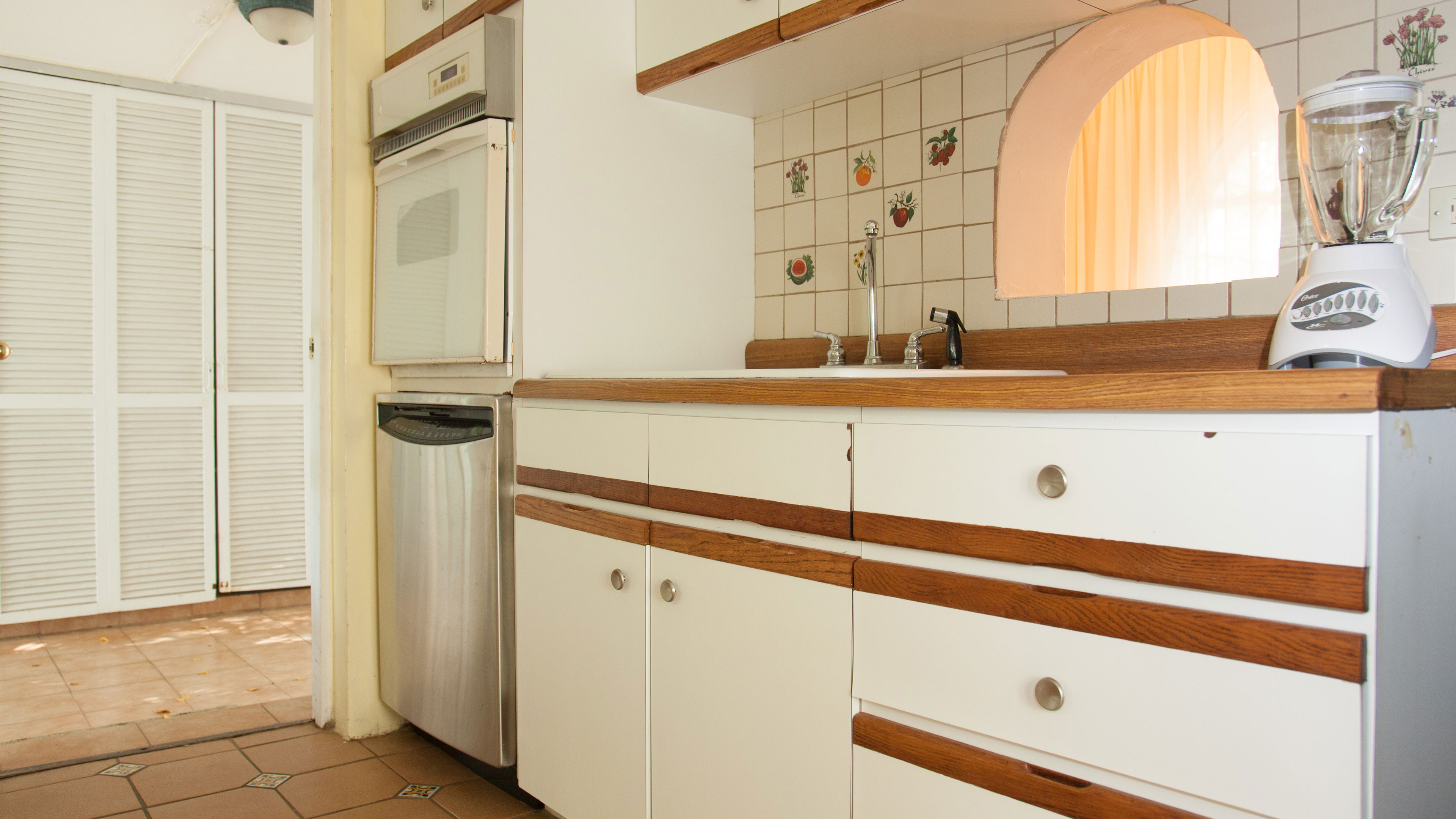 Kitchen has a little window into the dining room area